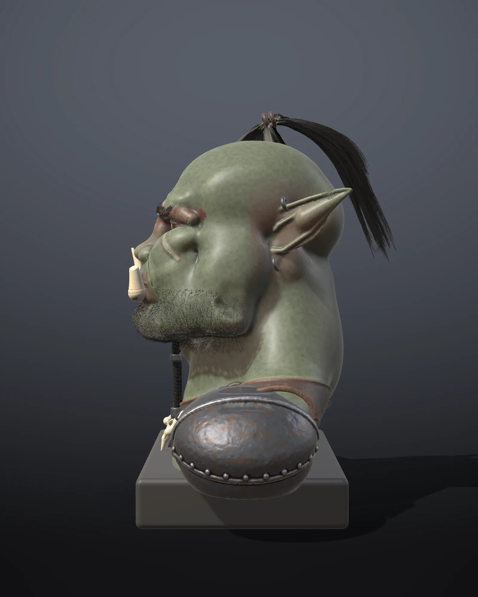 The orc bust in profile showing its groomed topknot, brows and stubble